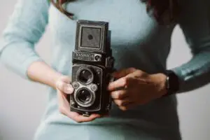 A photo of a woman holding a Yashica Mat 124