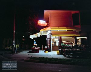 Cinematic Kodak Gold neon lights at night