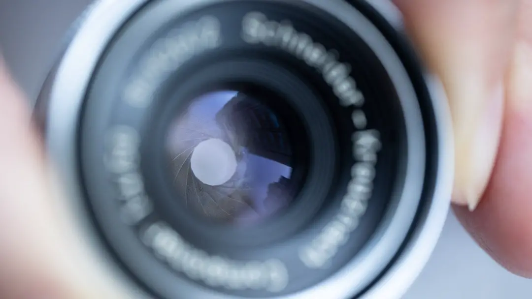 An image of an enlarger lens focused on the aperture blades.