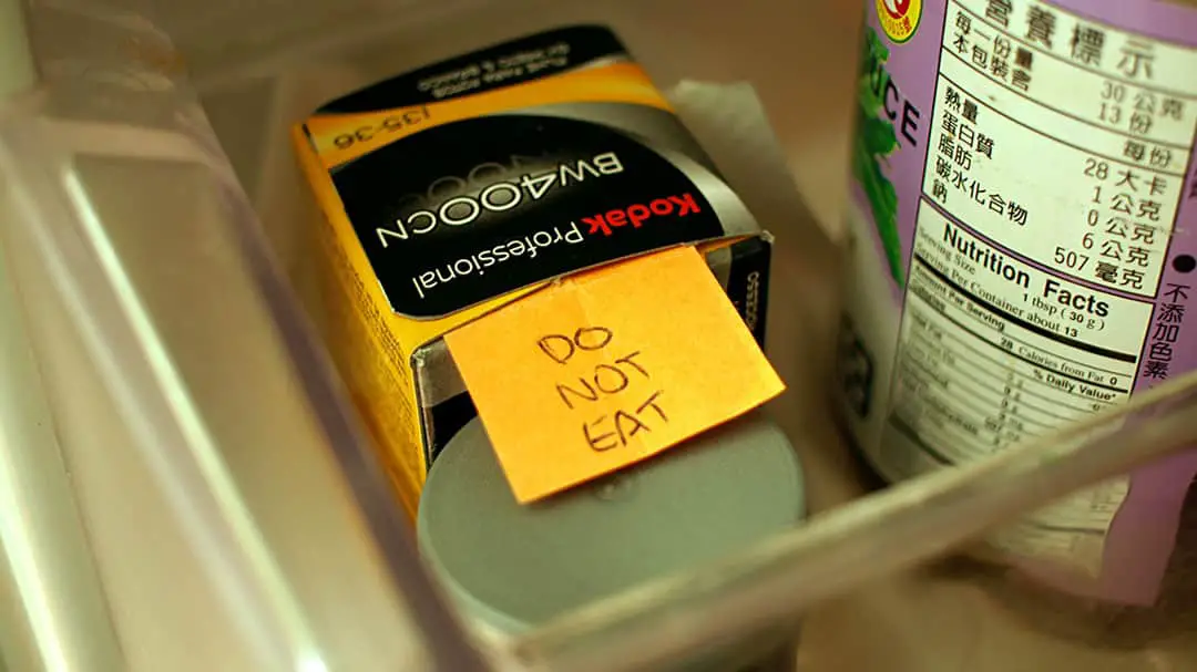 A roll of B&W super 8 film in the fridge with a cheeky note.