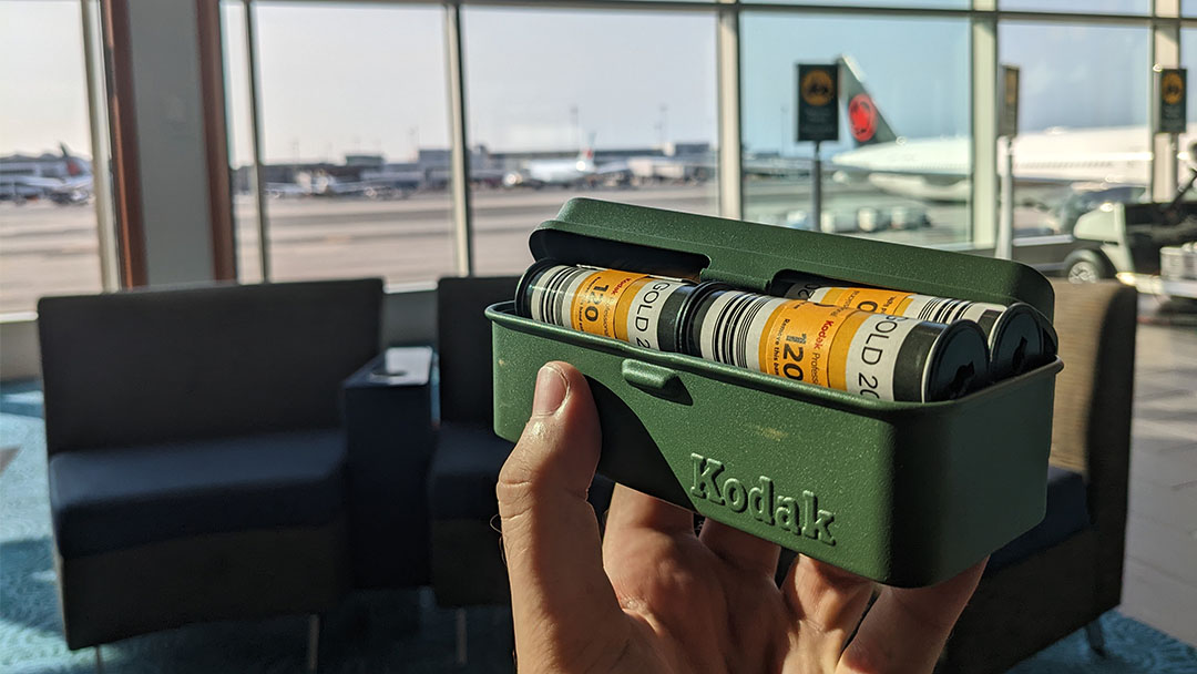 a film travel case in use at the airport. 