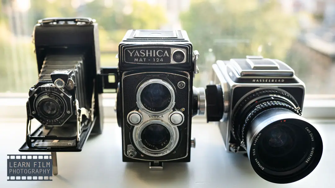 3 different types of medium format cameras. a TLR, a system camera, and a 627 camera